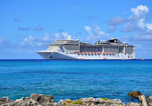Georgetown, Grand Cayman - September 19, 2017: Transatlantico MSC Divina anchored in the clear and turquoise waters of the Caribbean Sea. Every year the city receives thousands of tourist.